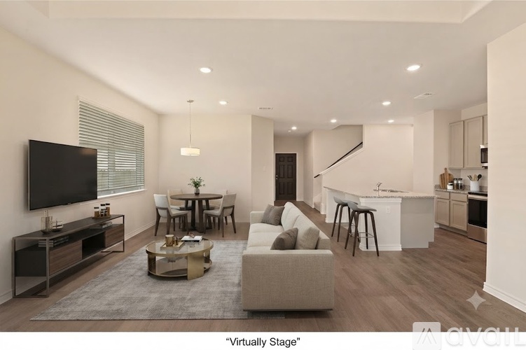 A modern living room with a television, a sofa, and a coffee table.