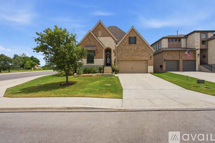 A house with a flag on the garage door is for sale.