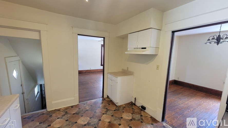 A room with a tiled floor and a white cabinet.