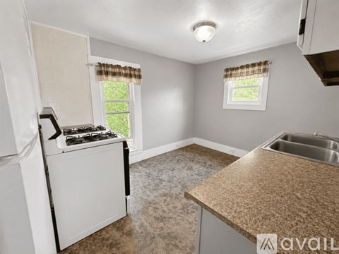 A kitchen with a white stove and a brown countertop.