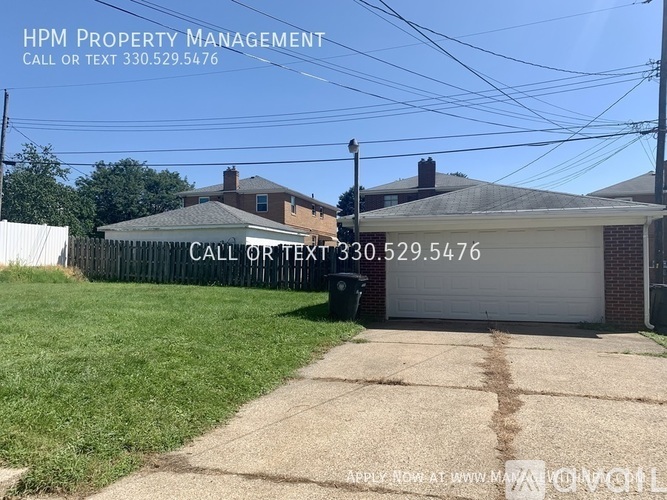 A sign for HPM Property Management is displayed in front of a house.