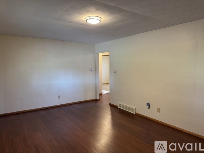 A room with wooden floors and a white door.