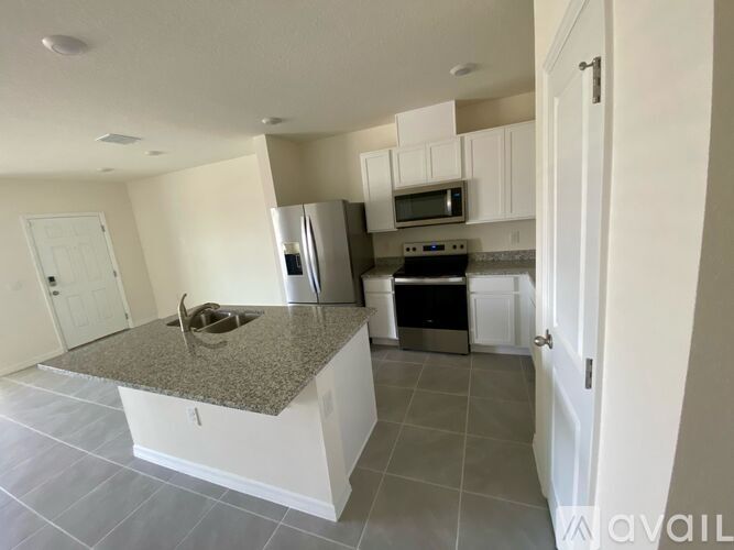 A kitchen with granite countertops and stainless steel appliances.