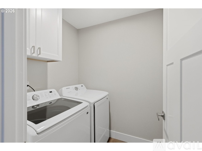 A small laundry room with a washer and dryer.