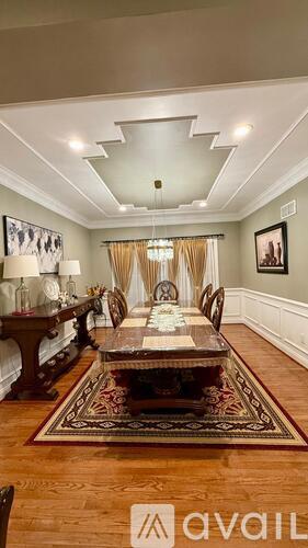 A dining room with a table set for six.