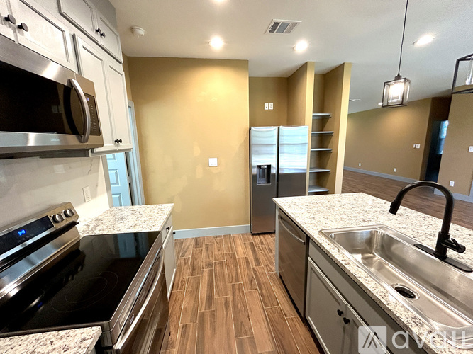 A kitchen with a stove top oven and a microwave.