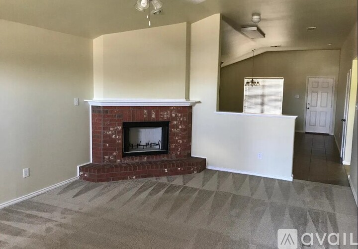 A living room with a fireplace and a carpeted floor.