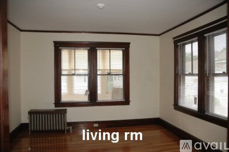 A living room with a window and a radiator.