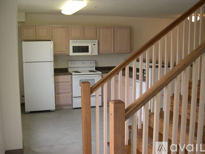 A kitchen with a white refrigerator and a white stove.