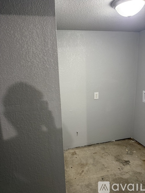 A room with a white wall and a light on.