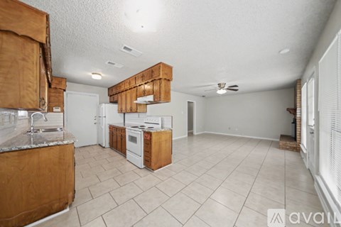 A kitchen with wooden cabinets and white appliances.