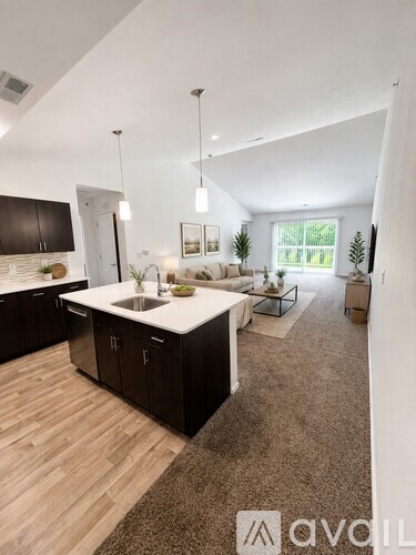A modern kitchen with dark wood cabinets and a white countertop.