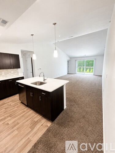 A modern kitchen with dark wood cabinets and a white countertop.