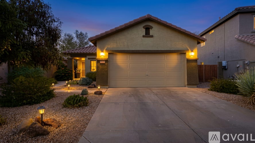 A house with a garage and driveway is available for sale.