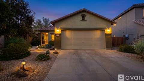 A house with a garage and driveway is available for sale.