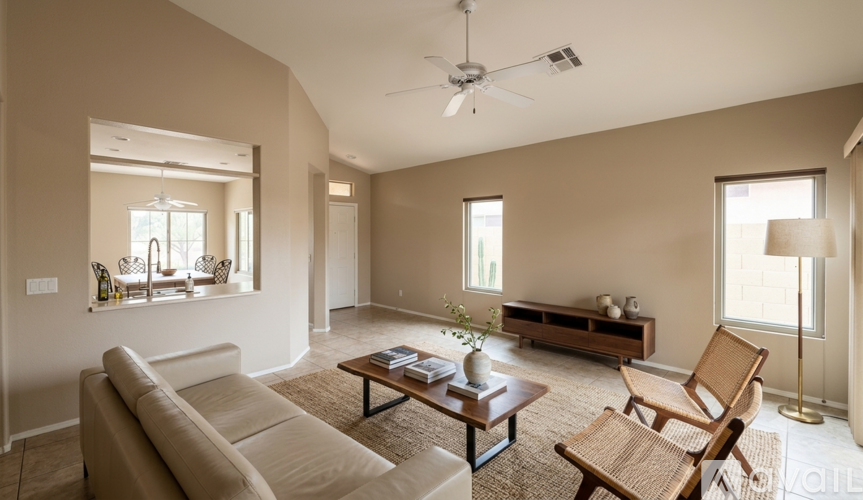 A living room with a couch, chair, and a coffee table.
