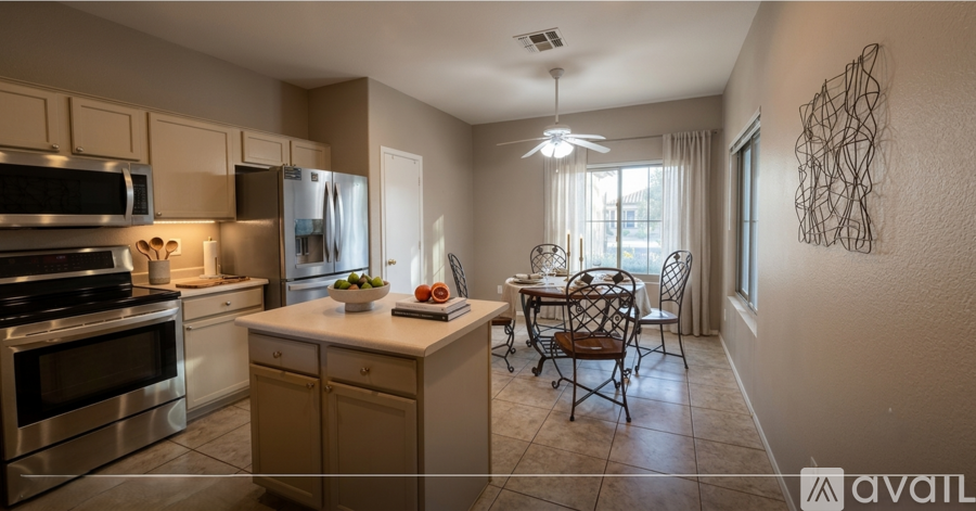 A kitchen with a table and chairs in the middle of the room.