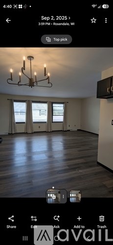 A room with wooden floors and a chandelier.