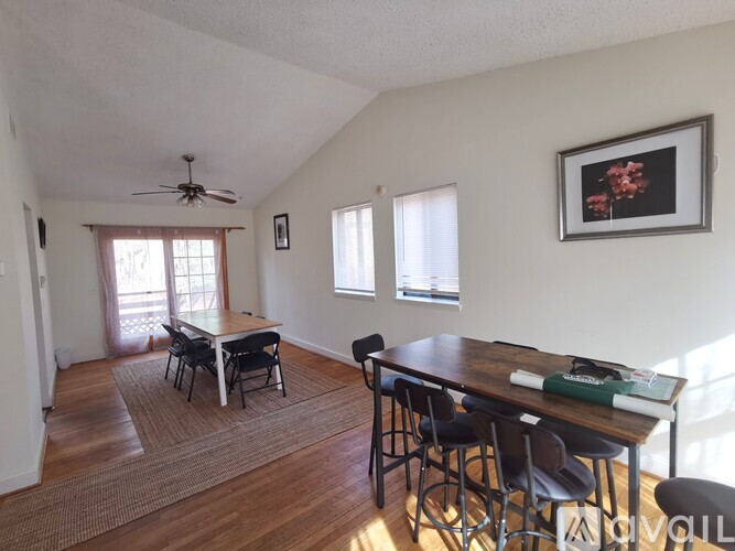 A dining room with a table and chairs.