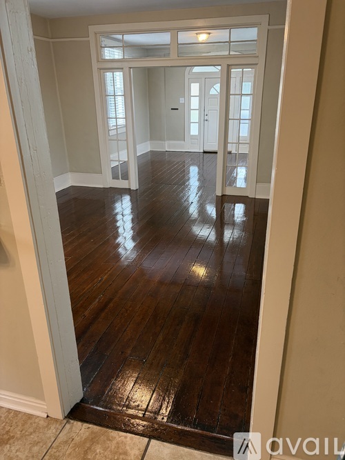 A room with wooden floors and white walls.