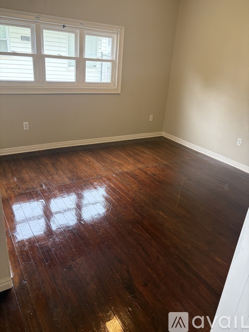 A room with wooden floors and a window.