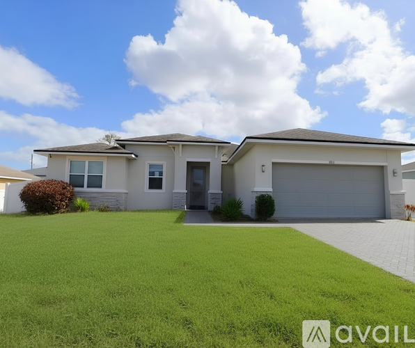 A house with a grey roof and a garage door.