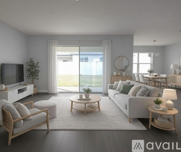 A modern living room with a flat screen TV, a sofa, a chair, and a coffee table.
