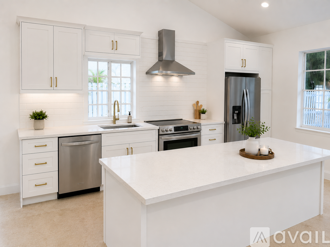 A modern kitchen with white cabinets and appliances.