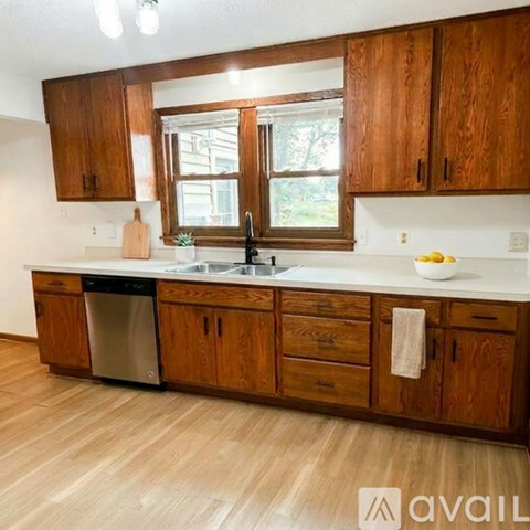 A kitchen with wooden cabinets and a white countertop.