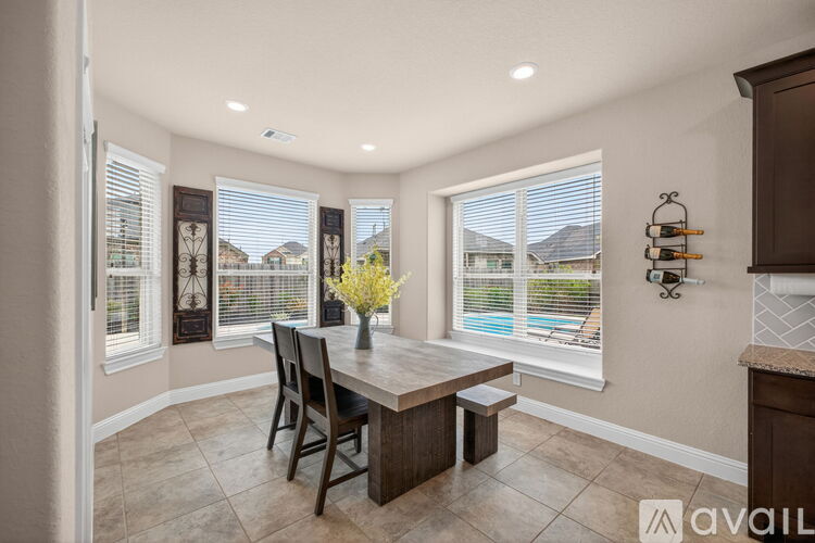 A dining room with a table and chairs is available for rent.