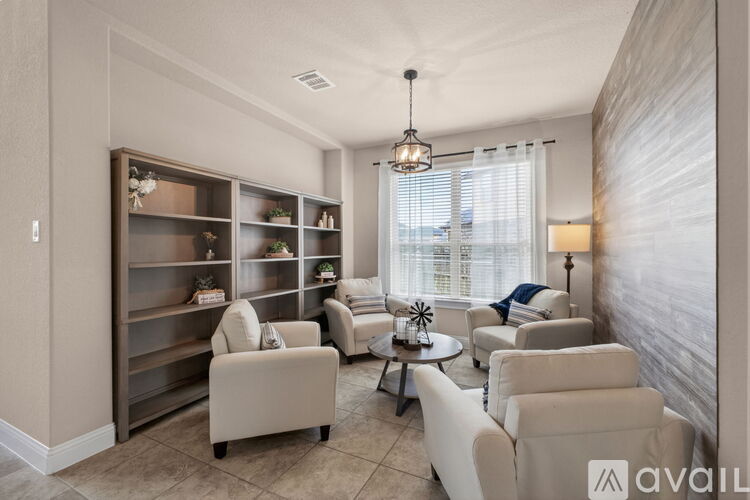 A living room with a large window, a sofa set, and a coffee table.