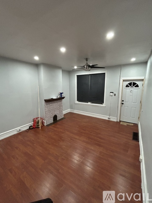 A room with a fireplace and a ceiling fan.