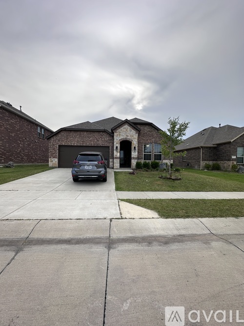 A car is parked in front of a house with a driveway.