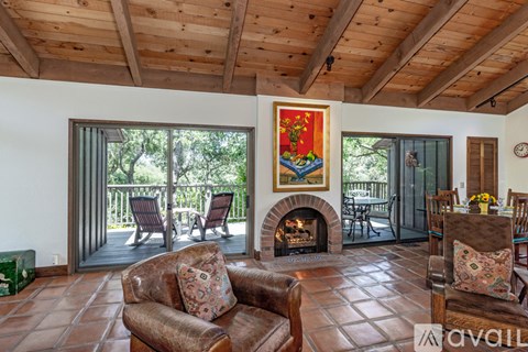 A living room with a fireplace and a painting on the wall.