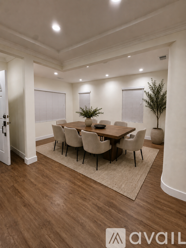 A dining room with a table set for six people.