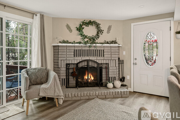 A cozy living room with a fireplace and a chair.