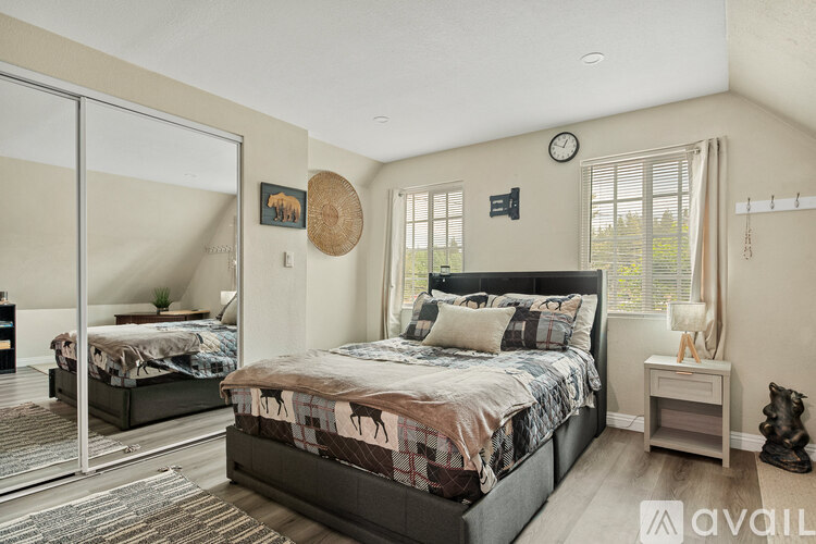 A bedroom with a large bed and a mirror on the wall.