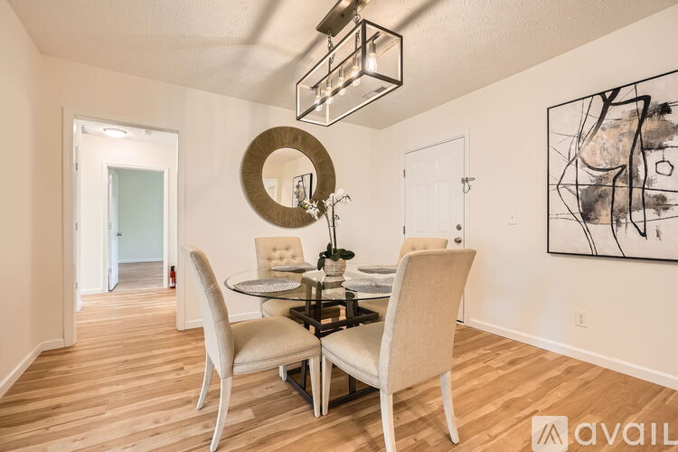 A dining room with a table and chairs.
