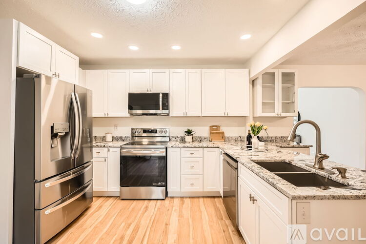 A kitchen with white cabinets and stainless steel appliances.
