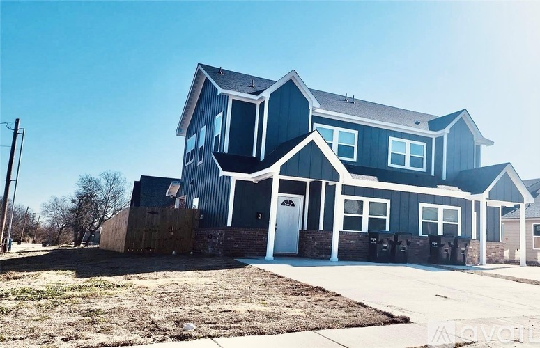 A blue house with a white door and windows.