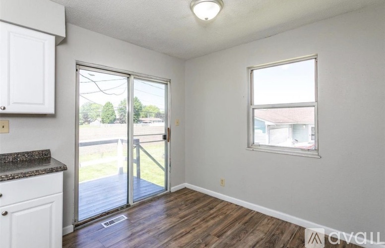 A room with a sliding glass door leading to a balcony.