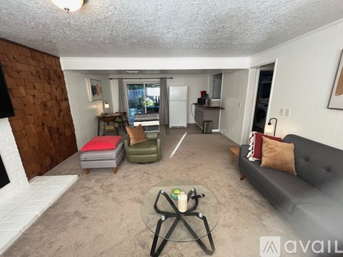 A living room with a grey couch and a coffee table in the middle.