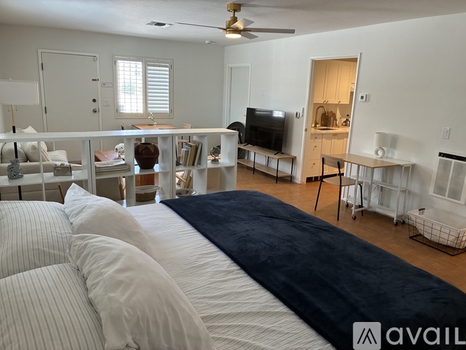 A bedroom with a large bed and a television in the corner.
