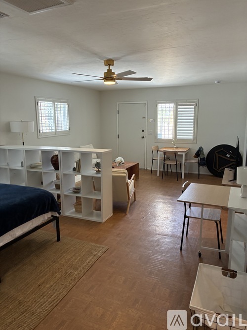 A bedroom with a bed, desk, and chair.