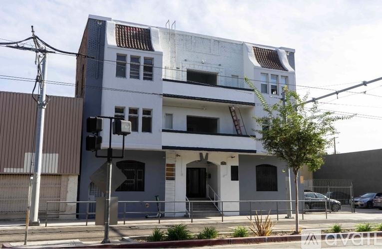 A modern two-story building with a white and grey exterior.