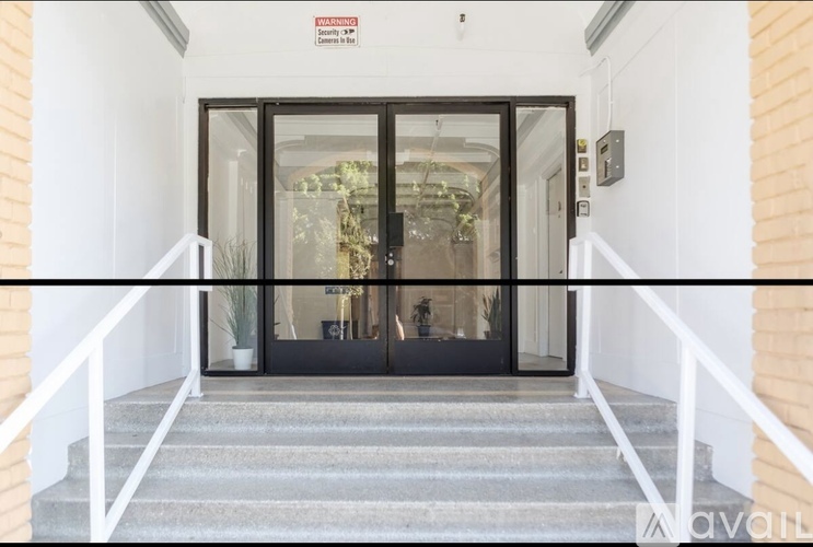 A set of stairs leads to a glass door entrance.