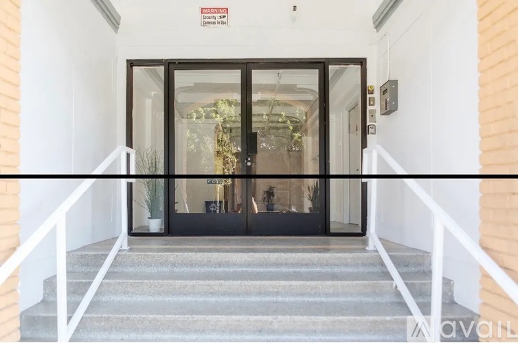 A set of stairs leads to a glass door entrance.