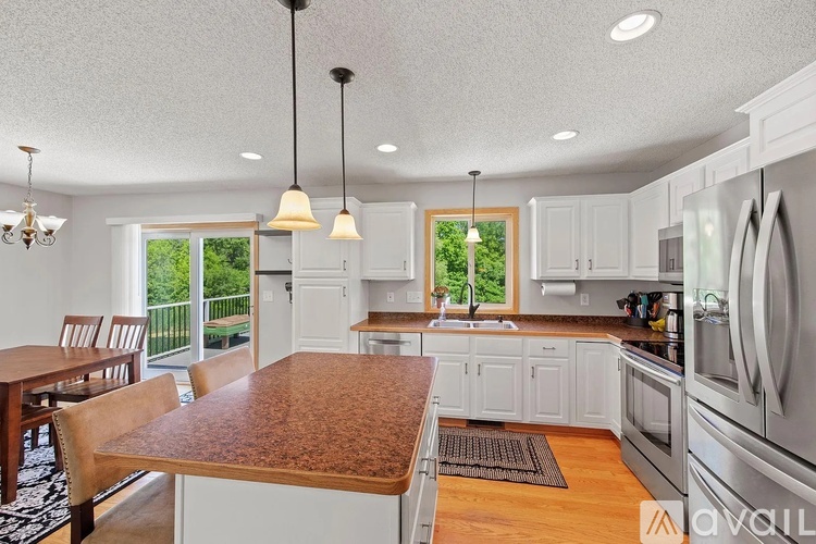 A kitchen with a table and chairs and a window.