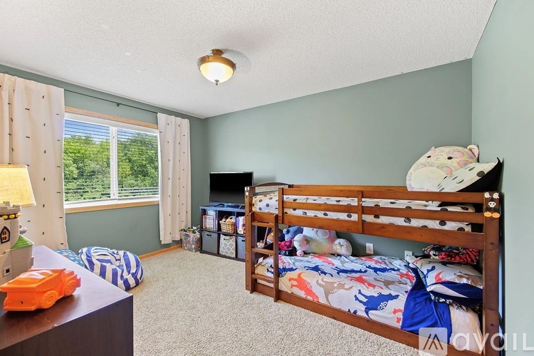 A bedroom with a bunk bed and a single bed.