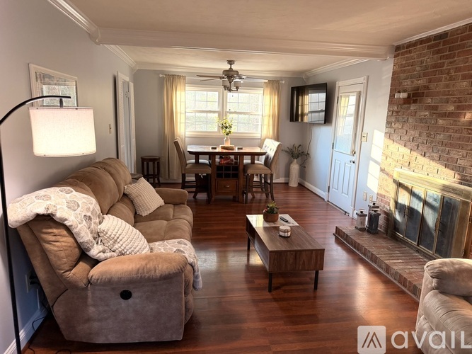 A living room with a couch, chairs, and a coffee table.